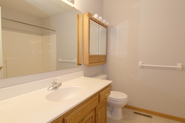 bathroom featuring toilet, a shower, and vanity