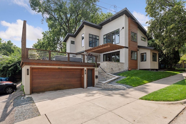 contemporary home with a front yard and a garage