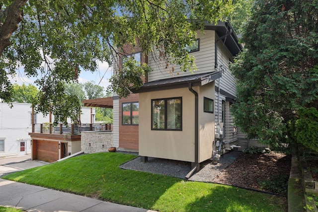 view of side of home with a yard