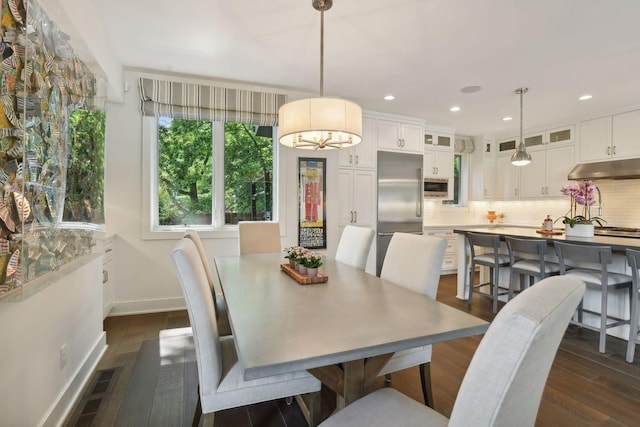 dining area featuring dark hardwood / wood-style floors and a chandelier