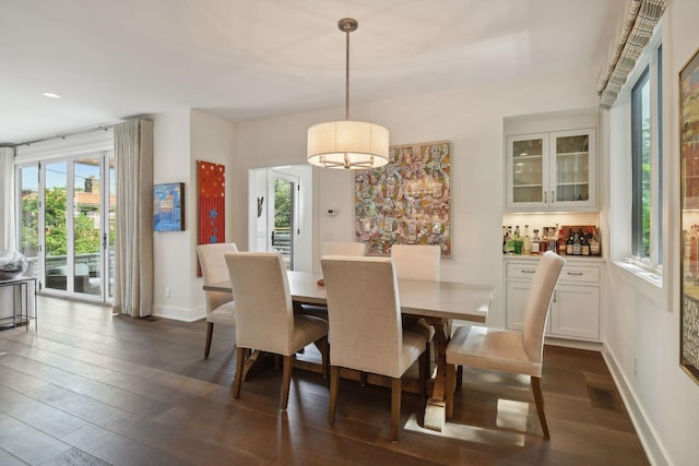 dining area with dark hardwood / wood-style floors