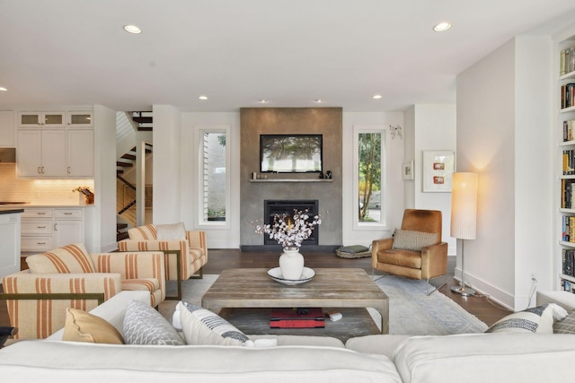 living room with wood-type flooring and a fireplace