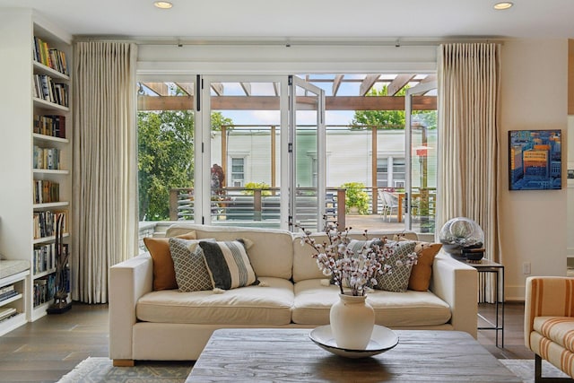 living room featuring plenty of natural light and hardwood / wood-style flooring