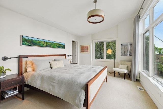 carpeted bedroom featuring vaulted ceiling