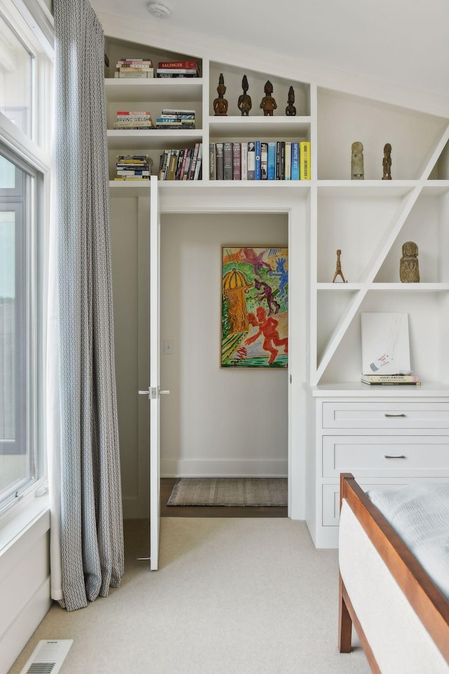 carpeted bedroom with lofted ceiling