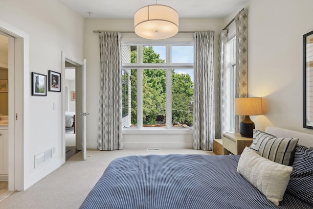 bedroom featuring light colored carpet