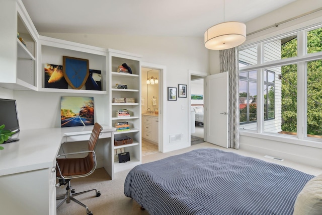 carpeted bedroom with ensuite bath, vaulted ceiling, and multiple windows