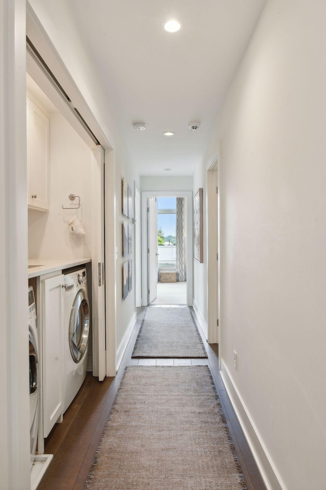 corridor with washer and dryer and hardwood / wood-style flooring