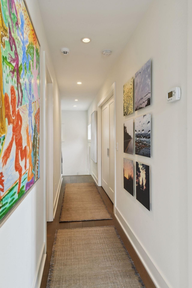 hallway with hardwood / wood-style floors