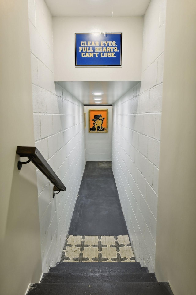 stairs featuring concrete flooring