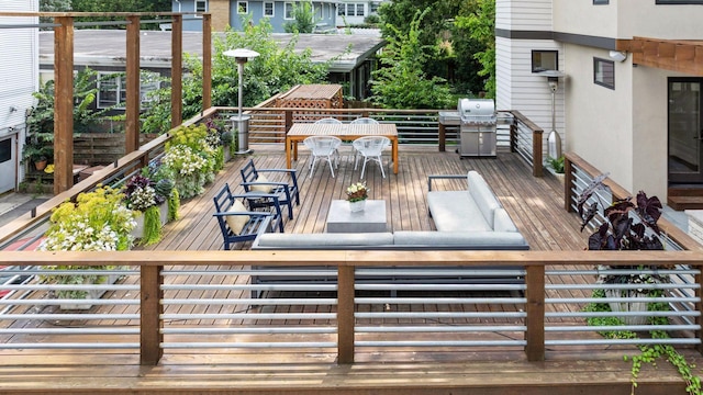 wooden deck featuring a grill