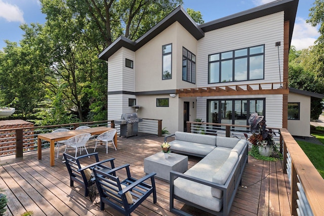 wooden deck featuring a grill and an outdoor hangout area