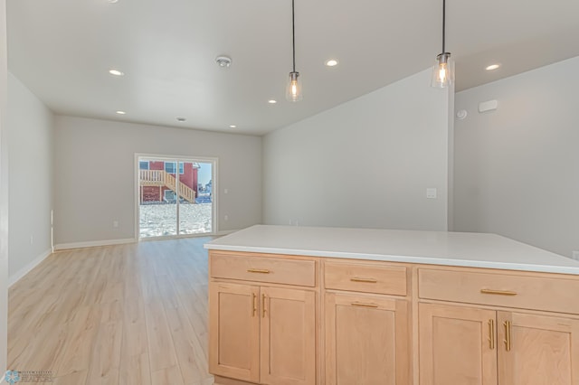 kitchen featuring light brown cabinetry, pendant lighting, and light hardwood / wood-style flooring