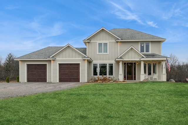 view of front facade with a garage, a front lawn, and covered porch