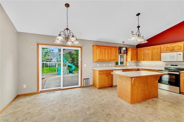 kitchen featuring a center island, lofted ceiling, white appliances, hanging light fixtures, and a chandelier