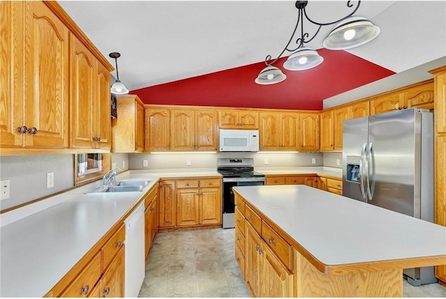 kitchen featuring sink, decorative light fixtures, lofted ceiling, a kitchen island, and appliances with stainless steel finishes