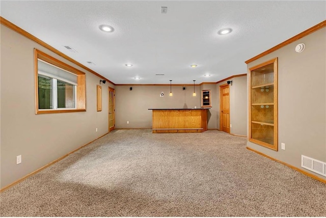 unfurnished living room with carpet, a textured ceiling, and crown molding