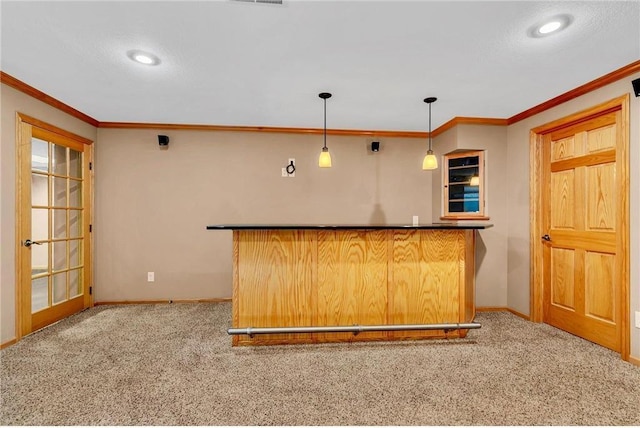 kitchen featuring pendant lighting, ornamental molding, light carpet, and a textured ceiling