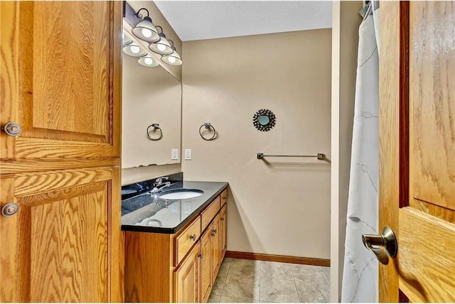 bathroom featuring tile patterned floors, vanity, and a textured ceiling