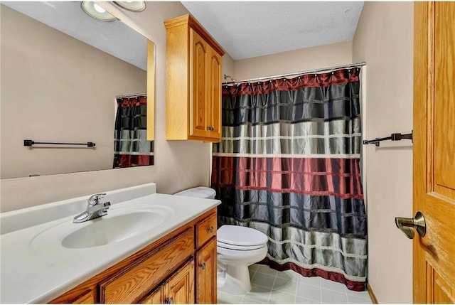 bathroom with vanity, a textured ceiling, and toilet