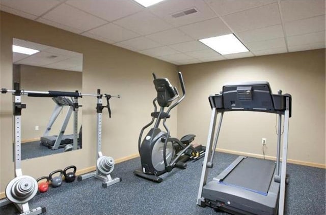 exercise area with a paneled ceiling