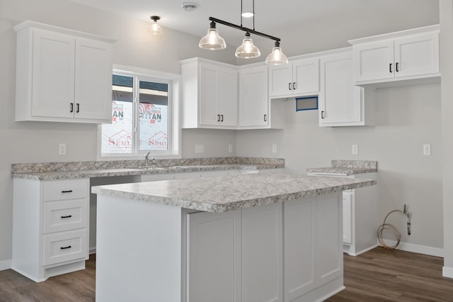 kitchen with white cabinetry, a center island, hanging light fixtures, and dark hardwood / wood-style floors