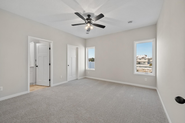 carpeted empty room with ceiling fan