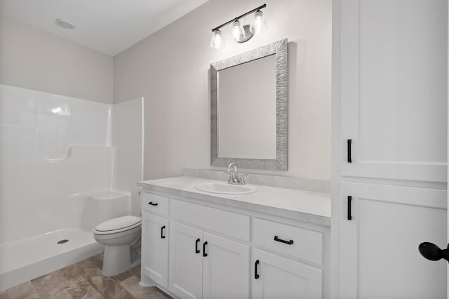 bathroom with vanity, toilet, and walk in shower