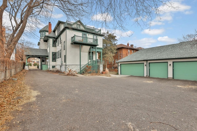 view of front facade featuring a balcony and a garage