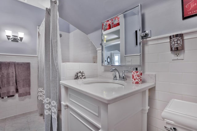 bathroom with vanity and tile walls