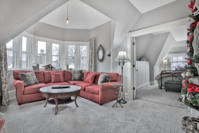 living room featuring light colored carpet and vaulted ceiling