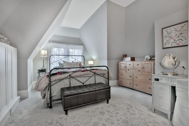 carpeted bedroom with lofted ceiling