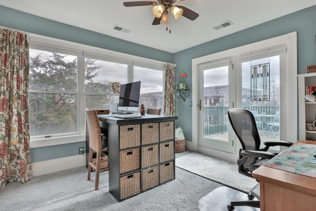 office area featuring light carpet and ceiling fan