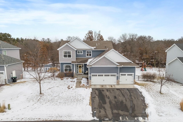 view of front of house featuring a garage, cooling unit, and driveway