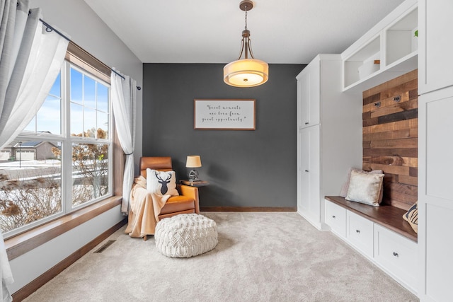 sitting room featuring visible vents, baseboards, and carpet