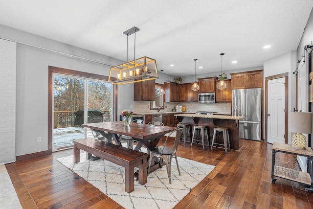 dining room with recessed lighting, dark wood-style flooring, and baseboards