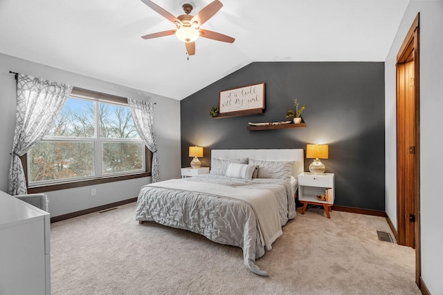 carpeted bedroom featuring visible vents, baseboards, ceiling fan, and vaulted ceiling