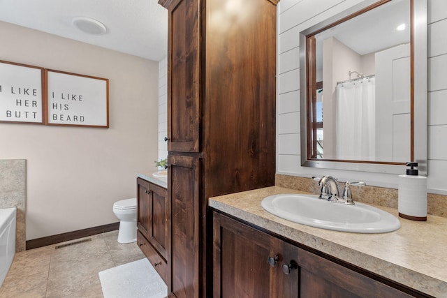 full bathroom featuring vanity, baseboards, visible vents, tile patterned flooring, and toilet