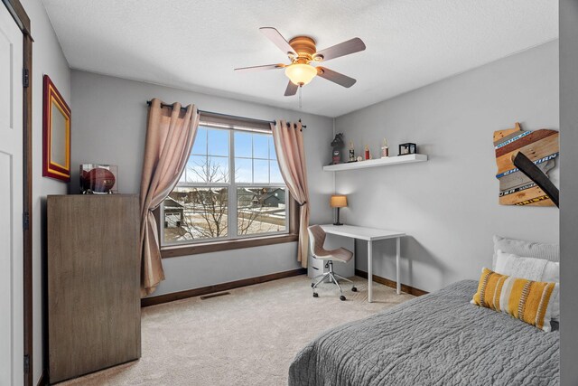 bedroom featuring visible vents, ceiling fan, baseboards, carpet, and a textured ceiling