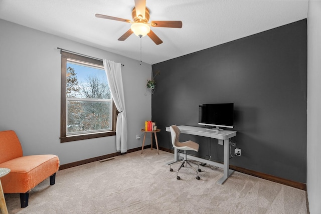 office featuring visible vents, baseboards, carpet, and a ceiling fan