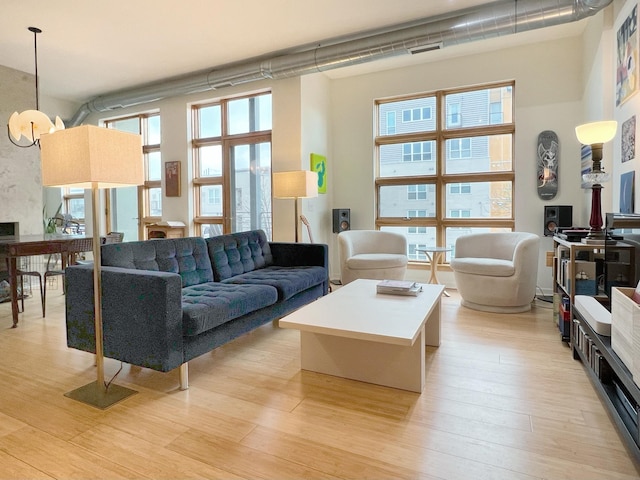 living room featuring a high ceiling and light hardwood / wood-style flooring