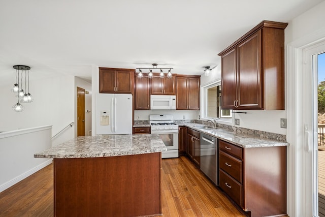 3876 Westbury Ln, Eagan, MN 55123 - kitchen with white appliances, a sink, wood finished floors, a center island, and hanging light fixtures