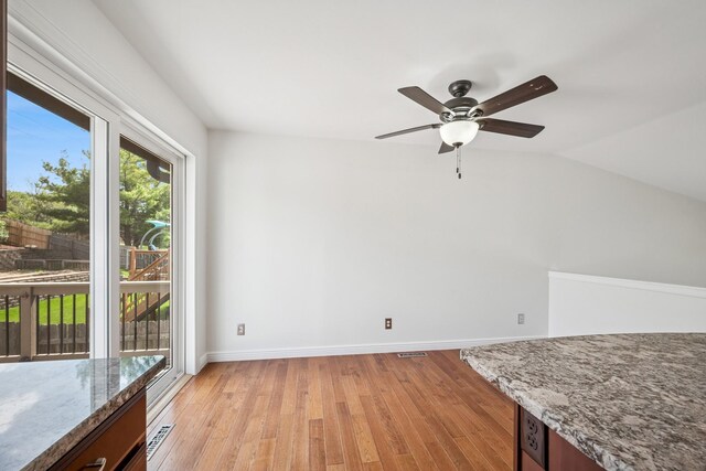 3876 Westbury Ln, Eagan, MN 55123 - unfurnished dining area with light wood-style floors, ceiling fan, baseboards, and lofted ceiling