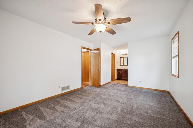3876 Westbury Ln, Eagan, MN 55123 - unfurnished bedroom featuring light carpet, baseboards, ensuite bath, a ceiling fan, and a textured ceiling