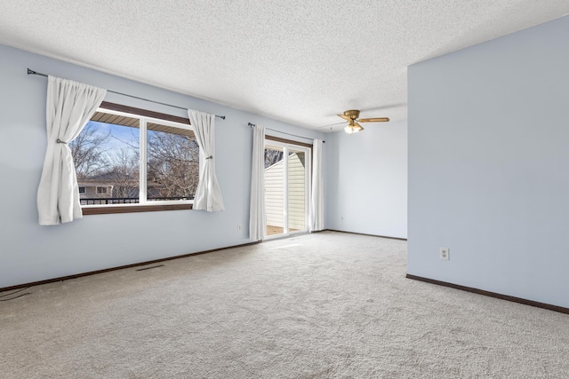 spare room featuring ceiling fan, carpet floors, and a textured ceiling