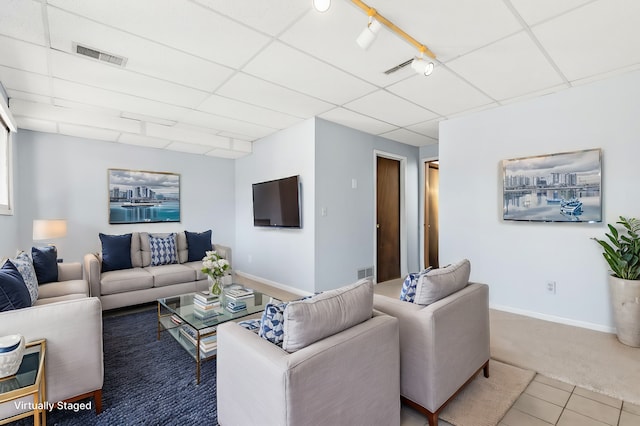 carpeted living room with rail lighting and a paneled ceiling