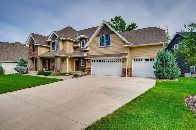 craftsman-style home with a front yard, a porch, and a garage