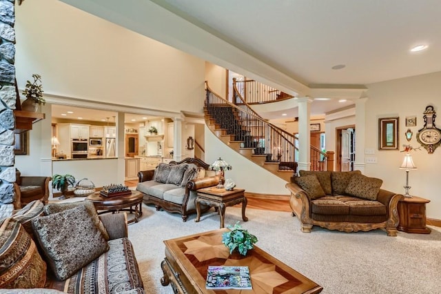 living room featuring decorative columns and carpet floors