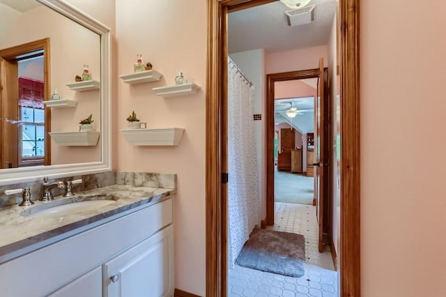 bathroom with tile patterned floors, vanity, and ceiling fan