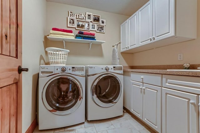 laundry room featuring cabinets, separate washer and dryer, and sink